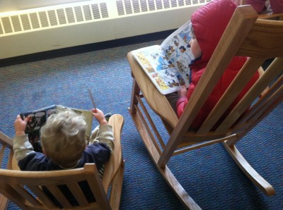 Lijah and Harvey on rocking chairs, a comic book each