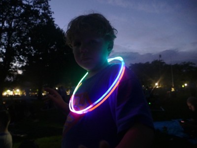 Zion in the dusk with glowstick hoops around his neck