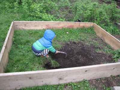 Lijah helping dig up grass for the new sandbox