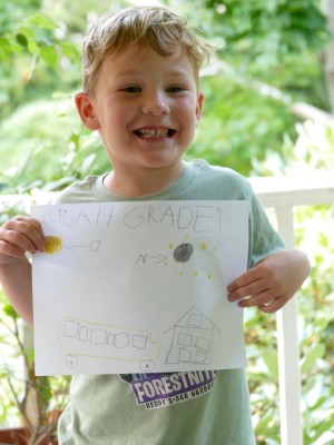 Elijah holding his grade 1 sign