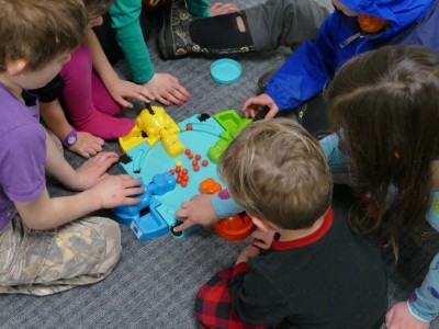 Lijah playing Hungry Hippos with some bigger kids
