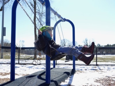 Elijah swinging at the playground