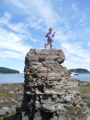 Elijah posing atop a rock tower