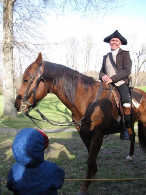Zion looking at a colonial reenactor on a horse