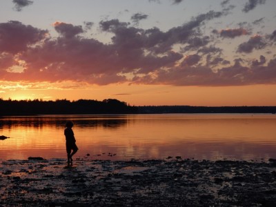 Elijah on the muddy beach at sunset
