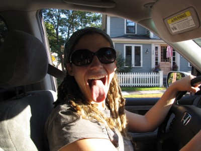 Leah in the driver's seat of the van, sticking out her tongue at the camera