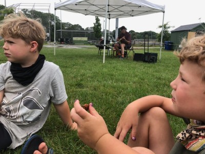 the boys listening to live music at the farmers market