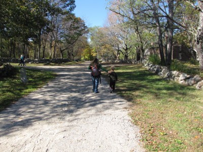 Leah and Harvey walking on the dirt road in Minuteman National Park
