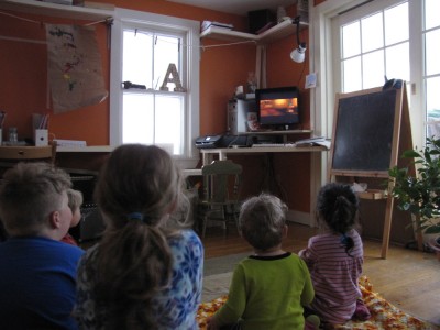 boys and friends watching a movie on the computer in the school room