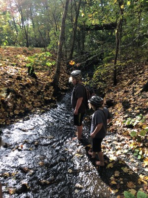 Harvey and Zion wading in a shallow stream