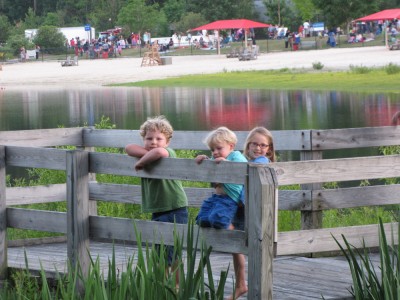 Harvey, Zion, and Taya posing on a bridge over the marsh