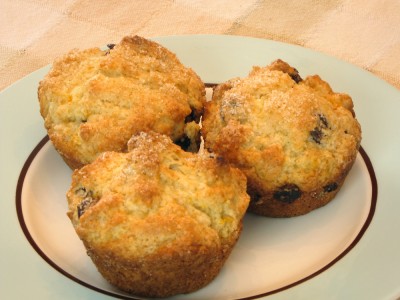 three orange chocolate chip muffins