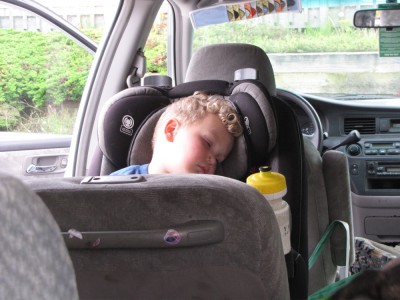 Lijah sleeping in his car seat with the doors open