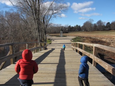 Lijah leading the other boys over the Old North Bridge