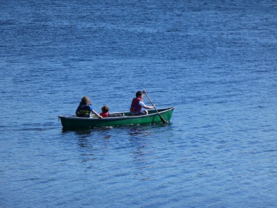 Zion, Elijah, and a friend canoing in blue water