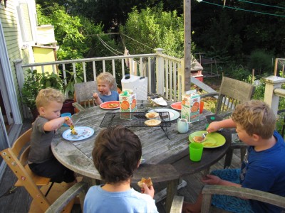 Harvey, Zion, Lijah, and Julen eating pancakes on the back porch