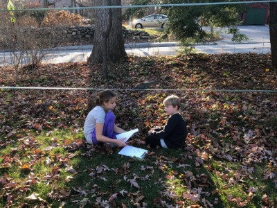 Zion and Havana working on math in the yard