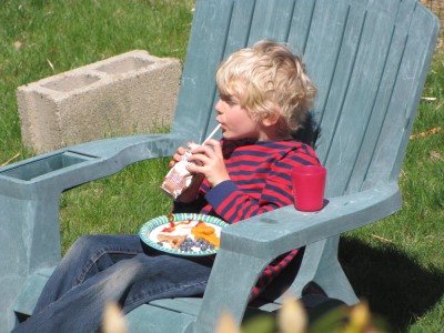Ollie enjoying lunch on a big lawn chair