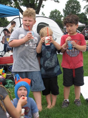 Harvey, Zion, Lijah, and Julen posing with red white and blue Italian ice