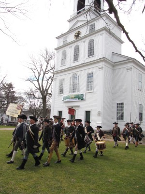 a Minute Company marching in front of the Bedford Meeting House