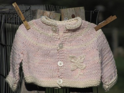 pink cotton sweater all on its own