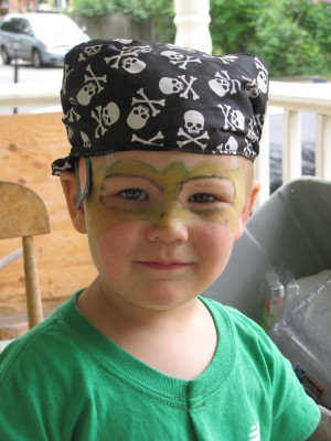 Lijah with pirate hat and dinosaur face paint