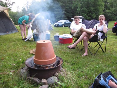 a terra-cotta pot inverted above the campfire