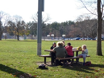 kids eating lunch at a picnic table by the playground