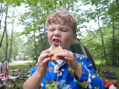 Elijah eating a smore at the campsite