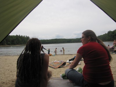 a view of Walden Pond under stormy skies from inside our beach tent