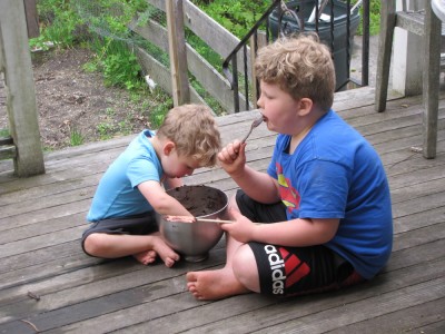 Lijah and Harvey on the porch, licking brownie batter from a bowl