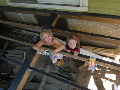 Elijah and a friend looking up through the joists in the un-decked porch
