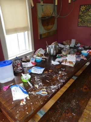 candy wrappers and crumbs covering the table after we made gingerbread houses