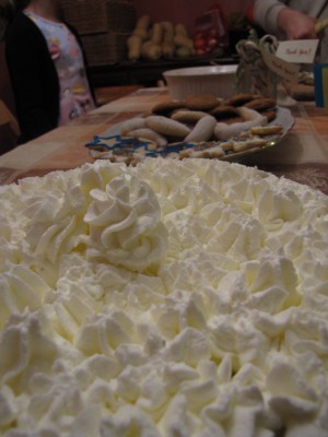 banana cream pie on the table with other treats in the background