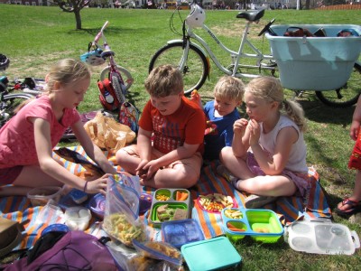 Harvey, Zion, Lucy, and Clara picnicing on the green