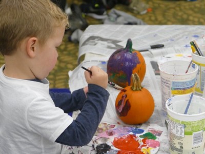 Lijah painting a pumpkin