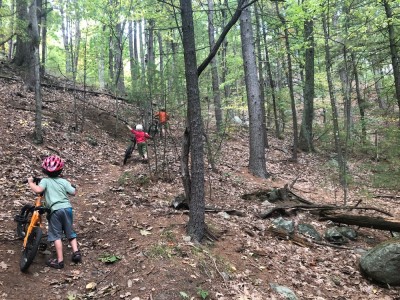 the boys pushing their bikes up a steep hill