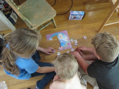 Zion, Harvey, and Havana doing a puzzle