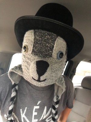 Zion with a raccoon hat over his face and Harvey's top hat on it