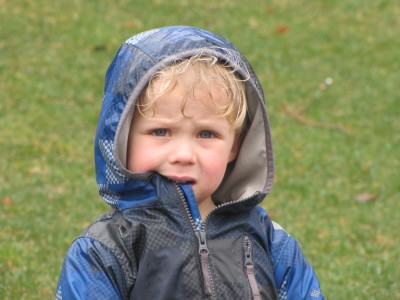 Zion in the rain, biting his raincoat collar