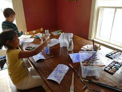 Elijah and a friend watercoloring at the kitchen table