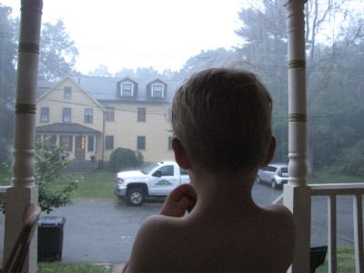 Zion watching late-evening rain from the front porch