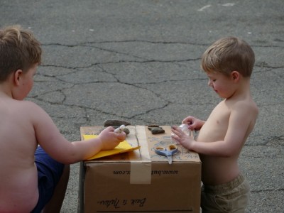 shirtless Harvey and Zion selling rocks at the side of the street