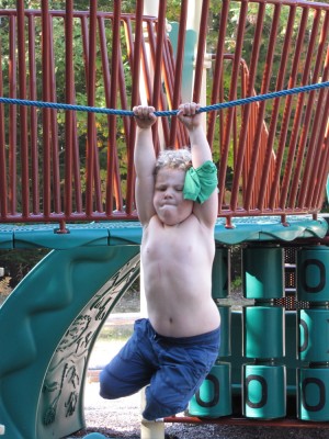 Harvey hanging from a horizontal rope on the playground