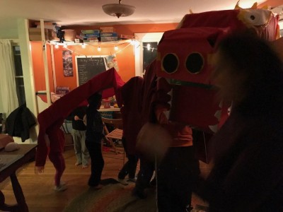 a homemade chinese new year dragon parading in our playroom