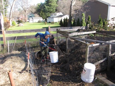 Harvey and Zion shoveling compost as school work