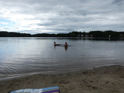 Zion and Elijah swimming in Freeman Lake under cloudy skies