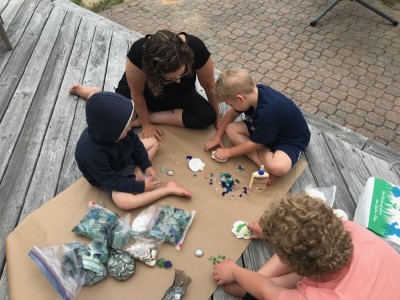 the boys gluing shells and sea glass with Grandma