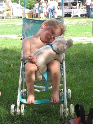 Lijah sleeping in the stroller, holding his pig