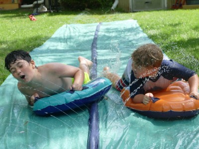 Zion and a friend on a slip-and-slide